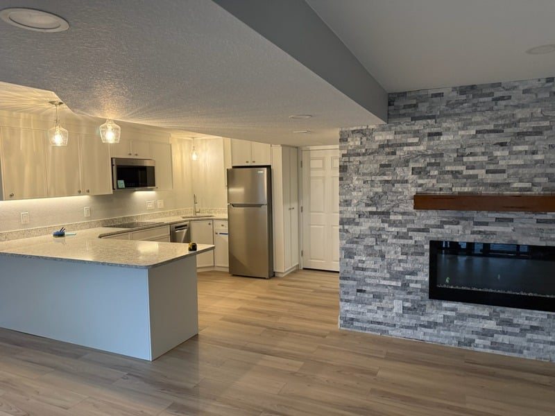 Bright open kitchen and living room with smooth ceilings